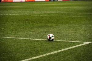 A soccer ball in the middle of a field.