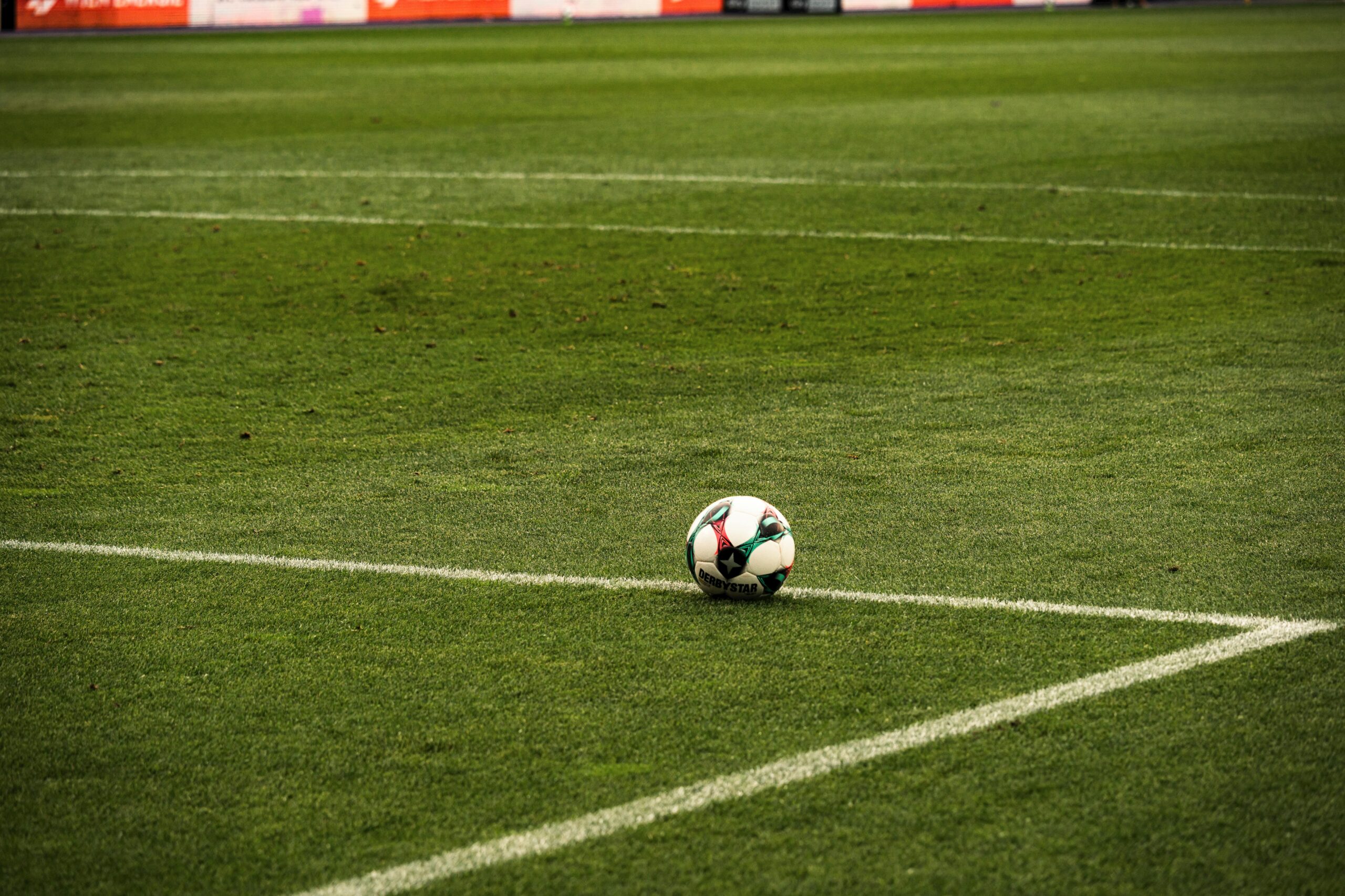 A soccer ball in the middle of a field.