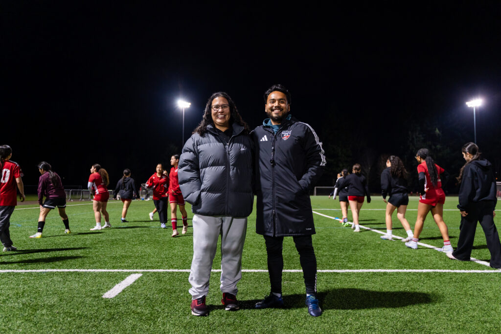 Executive Director Grizelda Sarria and Coach Danny Robles smile for a photo while
overseeing warm-ups for the 2011 and 2012 Girls team.
